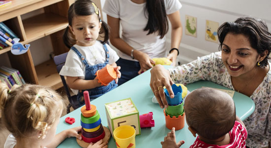 Teacher and children with fine motor toys in child care centre