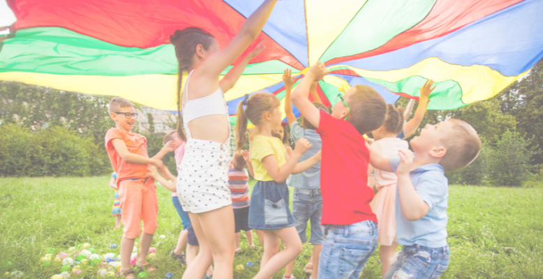Children playing with a parachute outdoors.